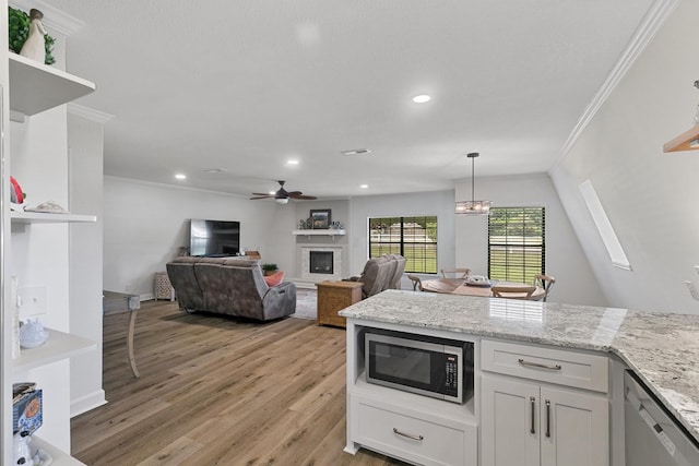 kitchen featuring open shelves, ornamental molding, a glass covered fireplace, light wood-style flooring, and appliances with stainless steel finishes