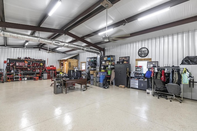 garage with a workshop area and a ceiling fan