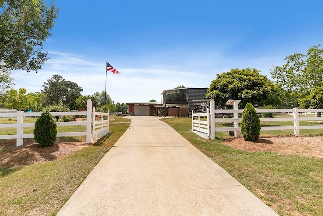 view of street with a gated entry and driveway