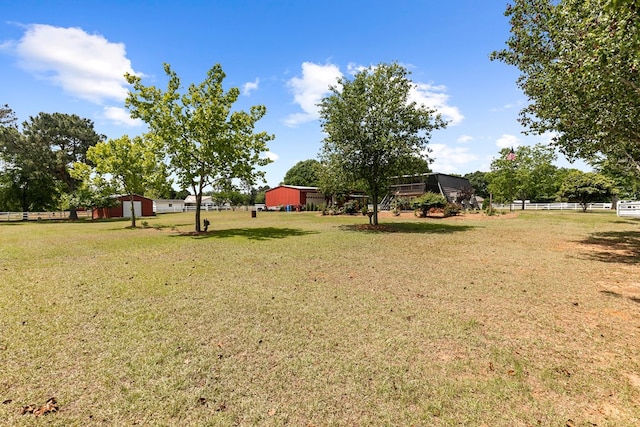 view of yard featuring fence and an outdoor structure