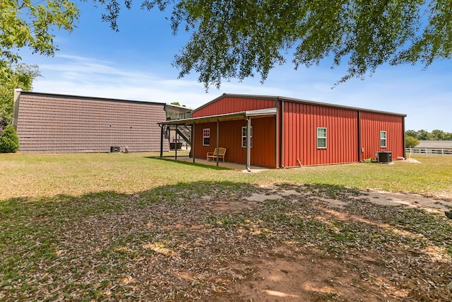 view of yard with central air condition unit, a patio, and a garage