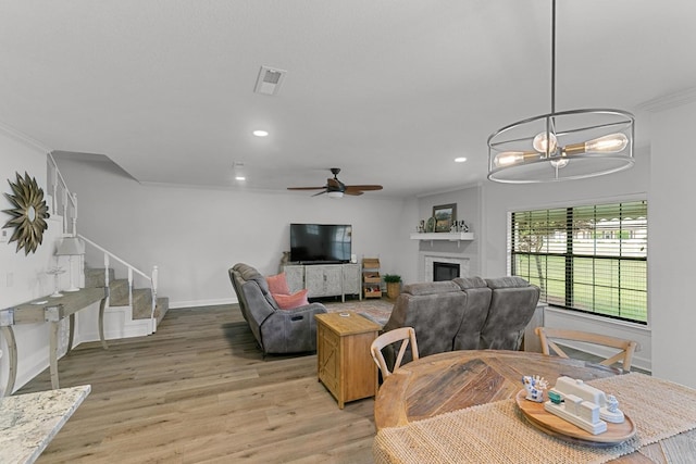 dining area with visible vents, stairs, light wood-style floors, recessed lighting, and ceiling fan with notable chandelier