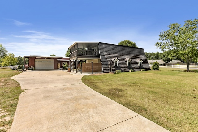 view of front of home featuring driveway, a front yard, a garage, fence, and stairs