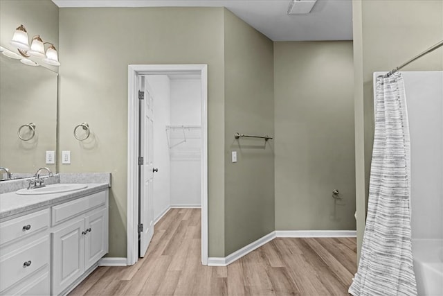 133 Brockton Ct, Dothan, AL 36305 - full bathroom with wood finished floors, vanity, a walk in closet, and curtained shower