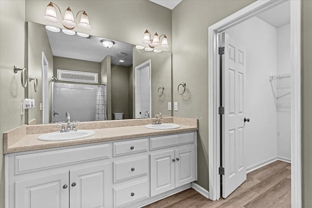 133 Brockton Ct, Dothan, AL 36305 - full bath with wood finished floors, double vanity, a spacious closet, and a shower with curtain