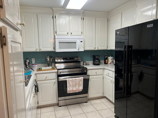 204 Melrose Ln, Dothan, AL 36303 - kitchen featuring black refrigerator with ice dispenser, stainless steel range with electric stovetop, white microwave, light countertops, and light tile patterned flooring