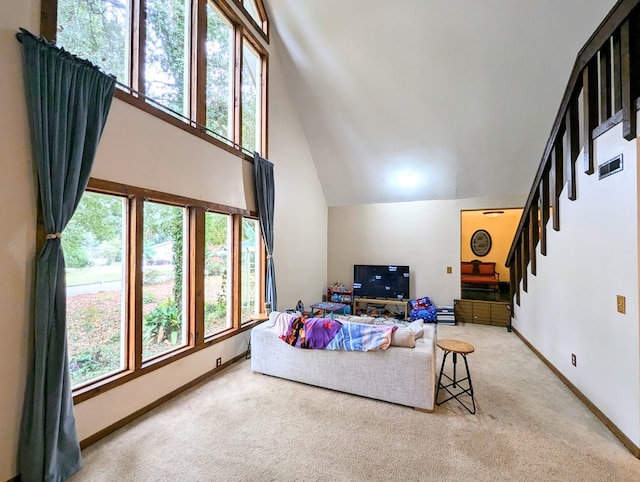 living room with carpet floors, plenty of natural light, and lofted ceiling