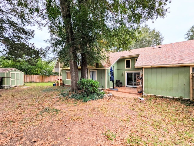 back of property with a storage unit