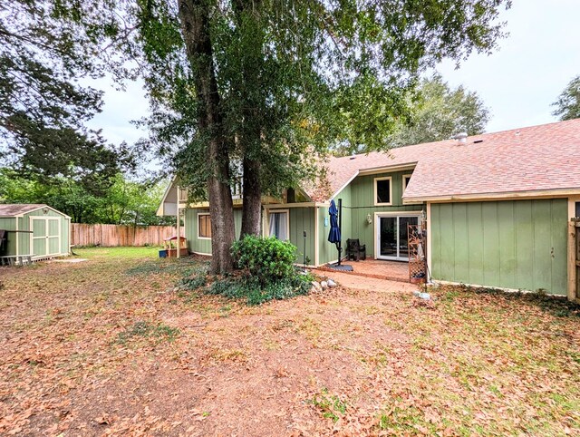 3602 Pebble Creek Ln, Dothan, AL 36303 - rear view of property with a storage shed, fence, an outdoor structure, and a shingled roof