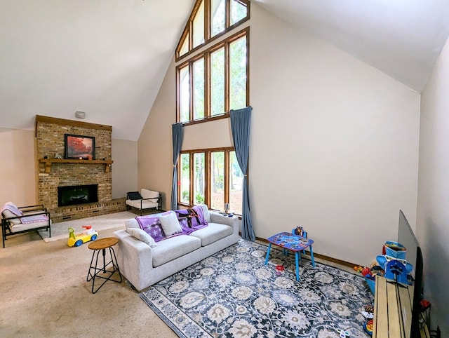 living room featuring a fireplace, carpet, high vaulted ceiling, and a wealth of natural light