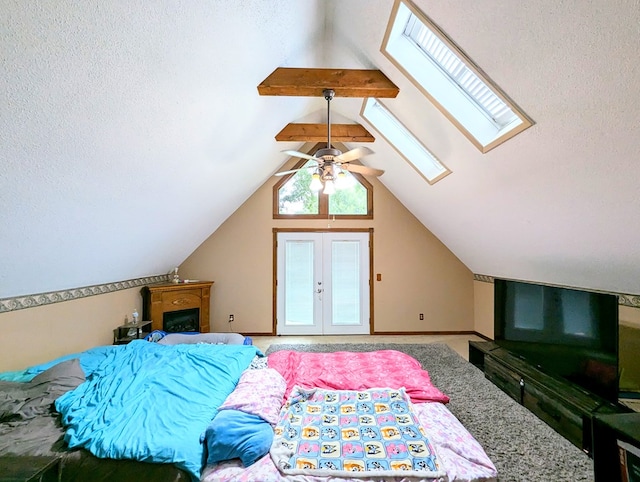 bedroom with lofted ceiling with skylight and ceiling fan