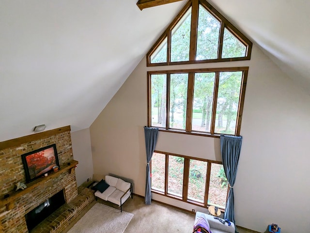 bonus room featuring high vaulted ceiling, a healthy amount of sunlight, a fireplace, and light carpet