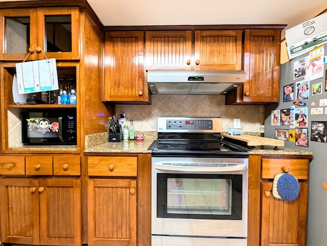 3602 Pebble Creek Ln, Dothan, AL 36303 - kitchen with under cabinet range hood, stainless steel appliances, brown cabinetry, backsplash, and light stone counters
