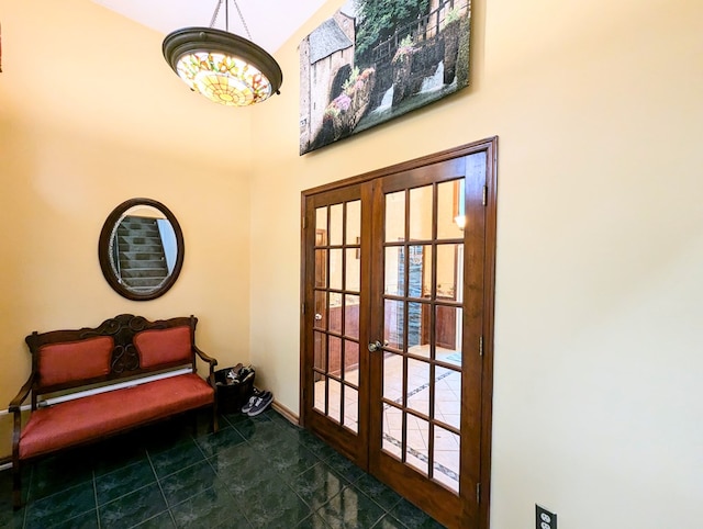 doorway to outside featuring french doors and dark tile patterned flooring