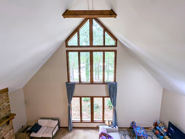 additional living space featuring beamed ceiling, light colored carpet, and high vaulted ceiling