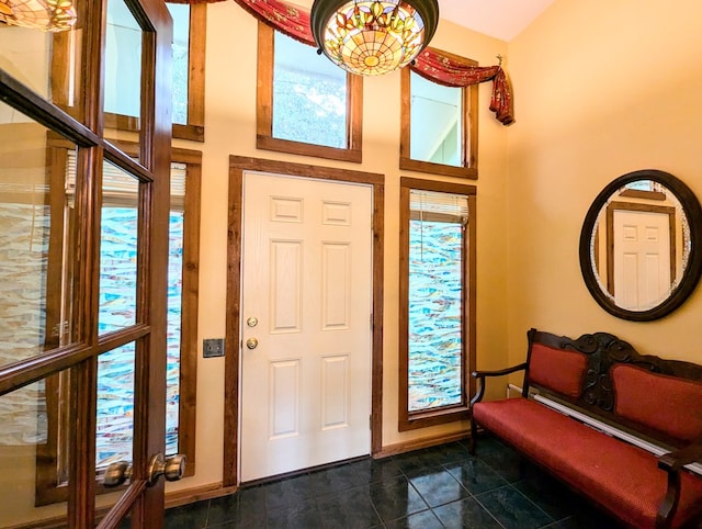 tiled foyer entrance with a towering ceiling