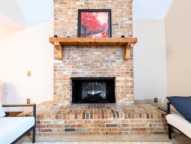 interior details with carpet floors and a brick fireplace