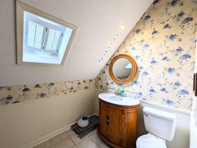 3602 Pebble Creek Ln, Dothan, AL 36303 - bathroom with wainscoting, wallpapered walls, lofted ceiling, toilet, and vanity