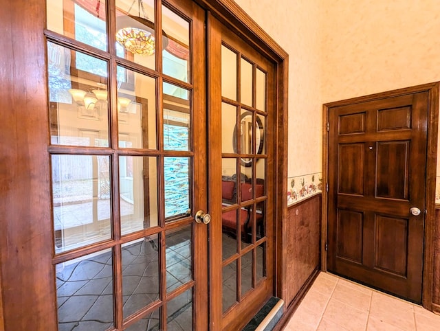 doorway to outside featuring french doors and light tile patterned floors