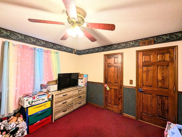 interior space with ceiling fan and a textured ceiling