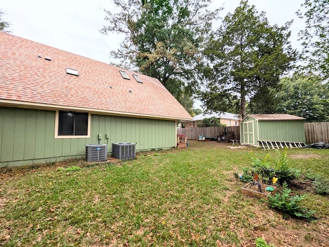 view of yard featuring a shed and central air condition unit