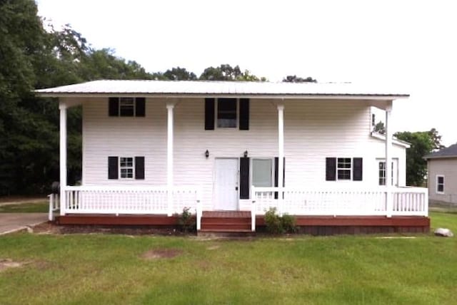 rear view of property with a yard