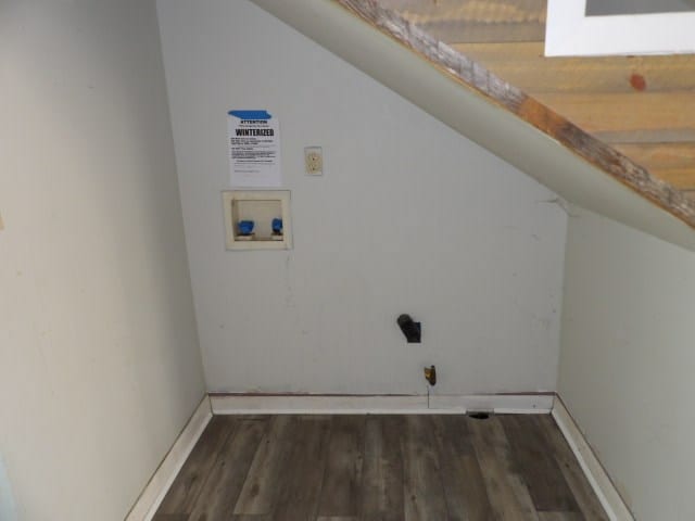 clothes washing area with washer hookup, electric dryer hookup, and dark wood-type flooring