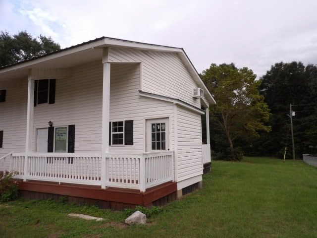 back of house featuring a yard