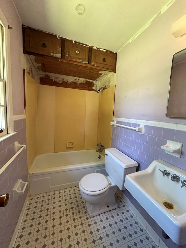 1000 Martin St, Dothan, AL 36301 - bathroom with a sink, toilet, tile walls, shower / bathing tub combination, and a wainscoted wall