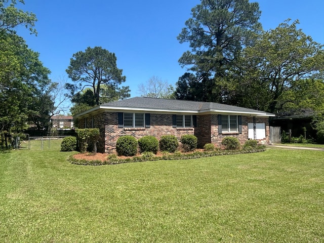 1000 Martin St, Dothan, AL 36301 - single story home with an attached garage, fence, a front lawn, and brick siding