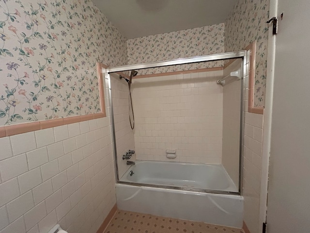 1000 Martin St, Dothan, AL 36301 - full bath with wallpapered walls, enclosed tub / shower combo, tile patterned floors, wainscoting, and tile walls