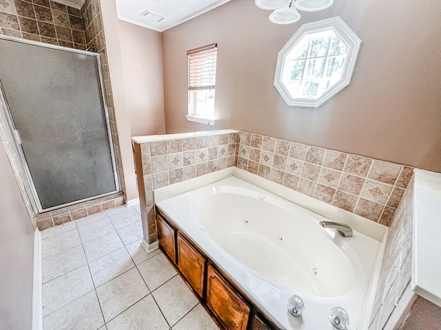 bathroom with a shower stall, tile patterned flooring, and a whirlpool tub