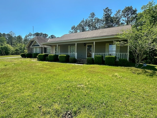 ranch-style home with a front yard and covered porch