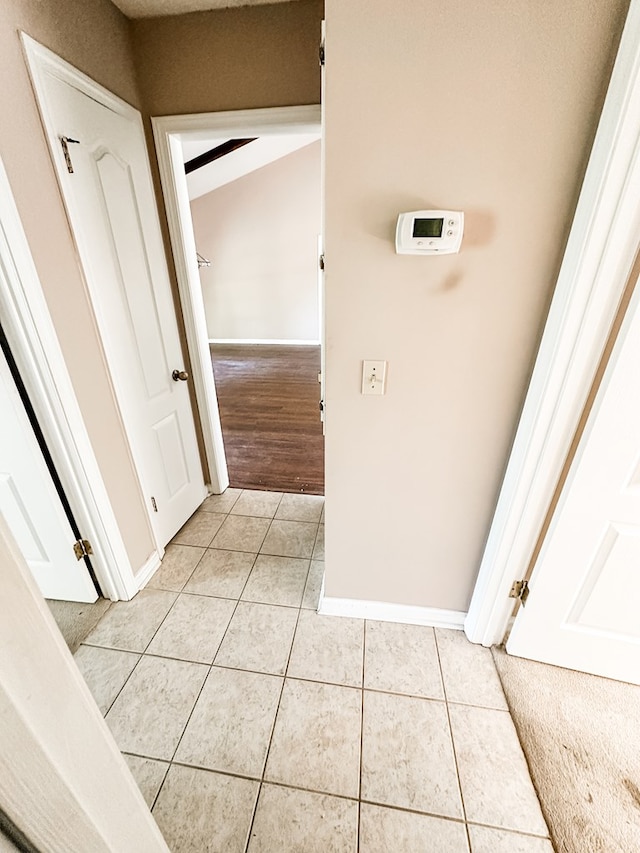 interior space with light tile patterned flooring and baseboards