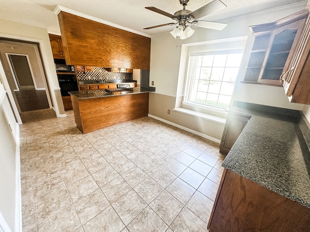 kitchen with crown molding, a ceiling fan, a peninsula, and brown cabinets