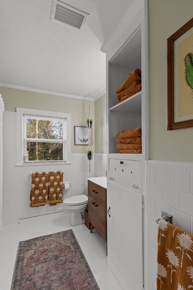 bathroom with toilet, a textured ceiling, tile walls, crown molding, and vanity