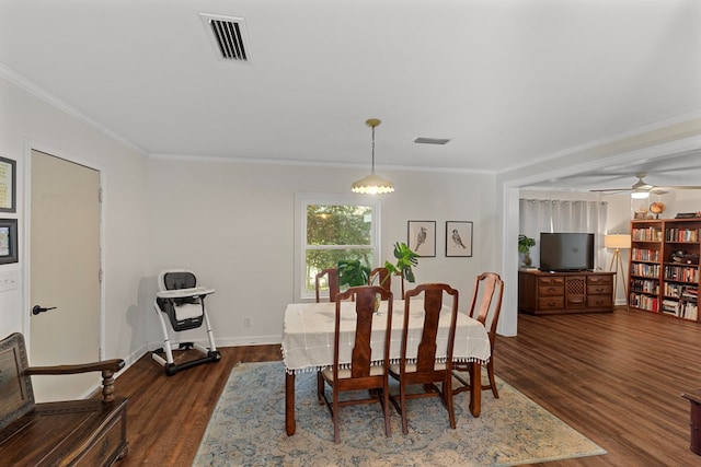 dining space with a notable chandelier, dark hardwood / wood-style floors, and ornamental molding