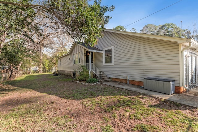 view of side of home featuring a lawn