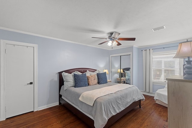 bedroom featuring a textured ceiling, dark wood-type flooring, crown molding, and ceiling fan