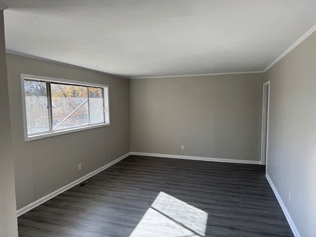 empty room featuring crown molding and dark hardwood / wood-style flooring