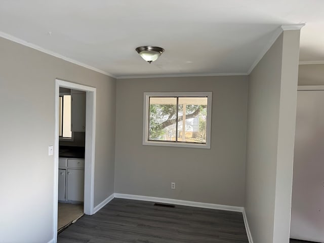 unfurnished room featuring ornamental molding and dark hardwood / wood-style floors