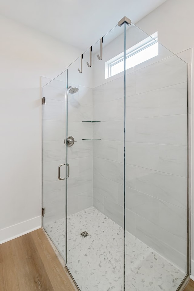 bathroom featuring hardwood / wood-style floors and walk in shower