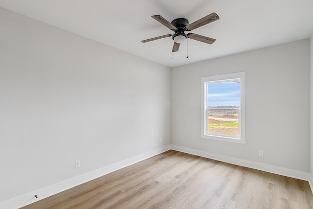 empty room featuring light hardwood / wood-style flooring and ceiling fan