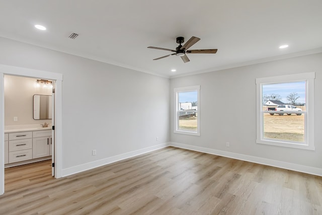 unfurnished bedroom featuring crown molding, light hardwood / wood-style flooring, and ensuite bathroom