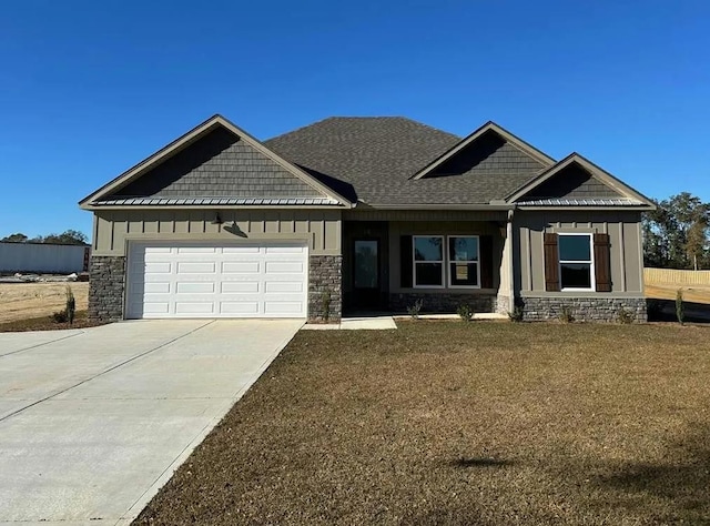 craftsman inspired home with a garage and a front yard