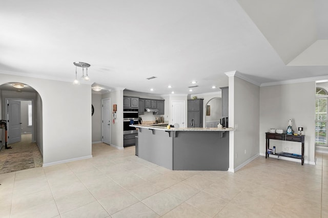 6 Piedmont Pl, Enterprise, AL 36330 - kitchen with a peninsula, a kitchen breakfast bar, ornamental molding, arched walkways, and light tile patterned floors