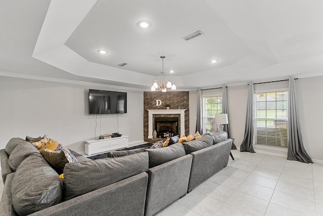 6 Piedmont Pl, Enterprise, AL 36330 - living area featuring a tray ceiling, light tile patterned floors, a large fireplace, recessed lighting, and a chandelier