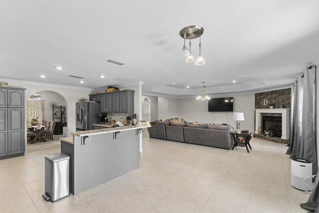 6 Piedmont Pl, Enterprise, AL 36330 - kitchen with arched walkways, stainless steel fridge with ice dispenser, open floor plan, crown molding, and light tile patterned flooring