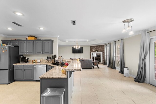 6 Piedmont Pl, Enterprise, AL 36330 - kitchen with appliances with stainless steel finishes, a peninsula, gray cabinets, crown molding, and light stone counters