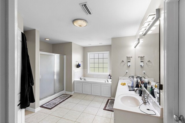 6 Piedmont Pl, Enterprise, AL 36330 - bathroom featuring a shower stall, a bath, double vanity, and tile patterned floors